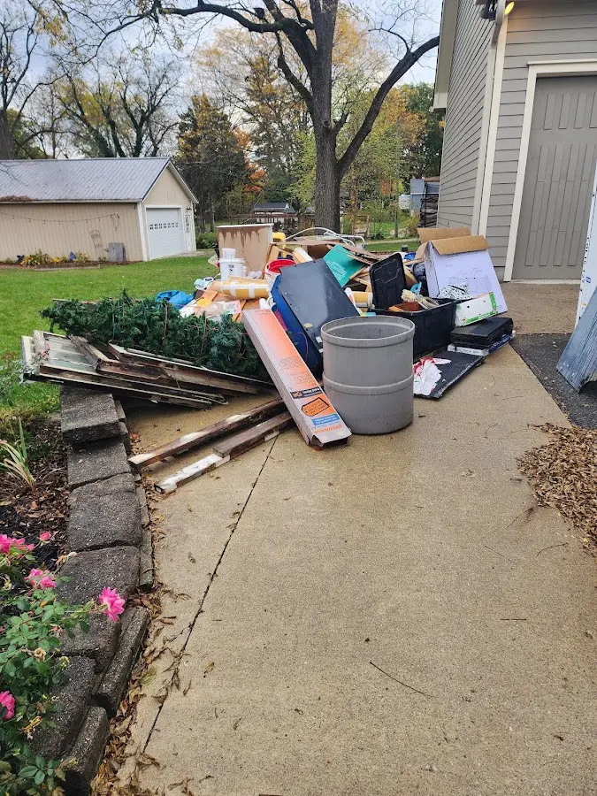 Dumpster being loaded with debris for Demolition Dumpster Rental in Clinton